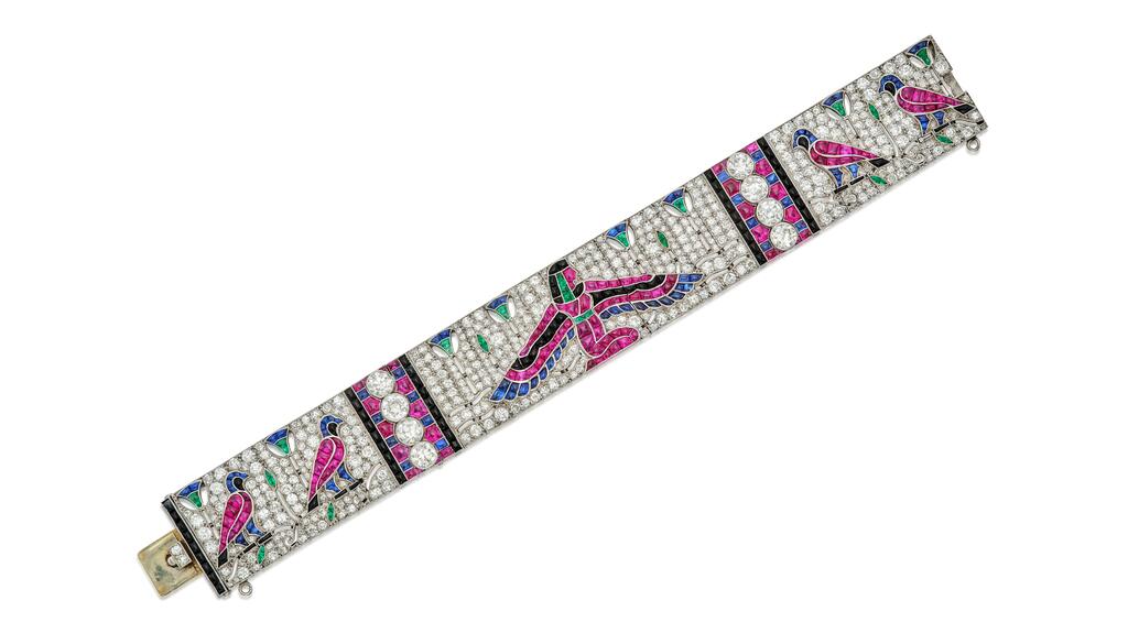 An example of Egyptian Revivalism, the bracelet features a depiction of the goddess Isis, as well as Horus falcons and papyrus reeds, set throughout with diamonds, rubies, sapphires, emeralds, and black onyx. Sotheby’s 1925 Egyptian bracelet